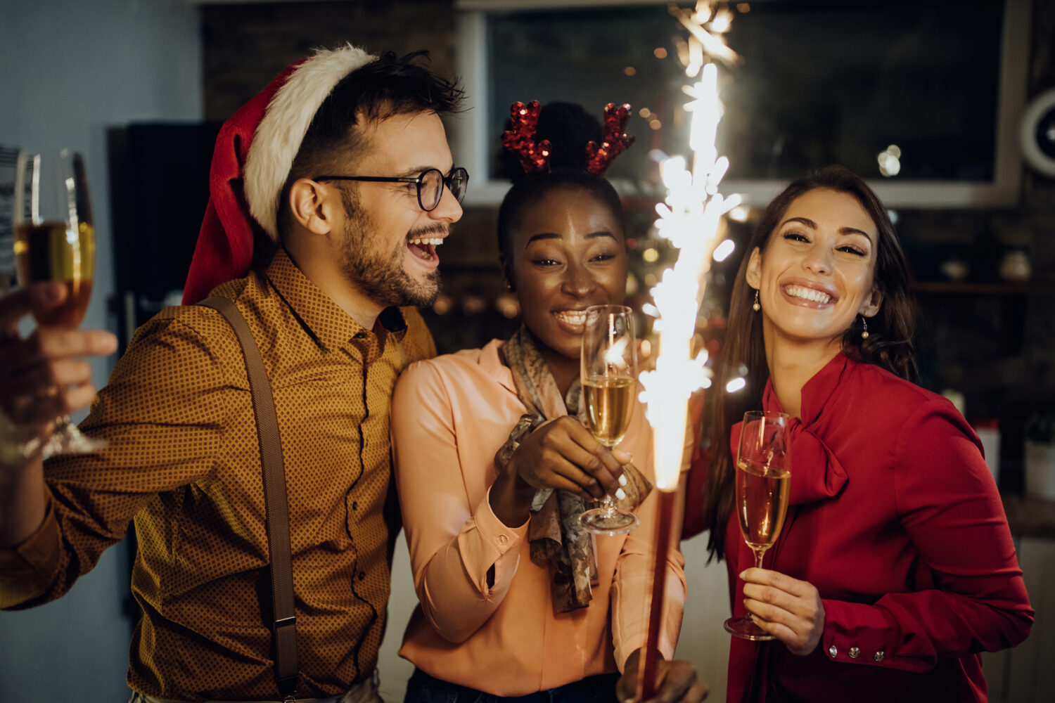 Cheerful friends drinking champagne and having fun on New Year's